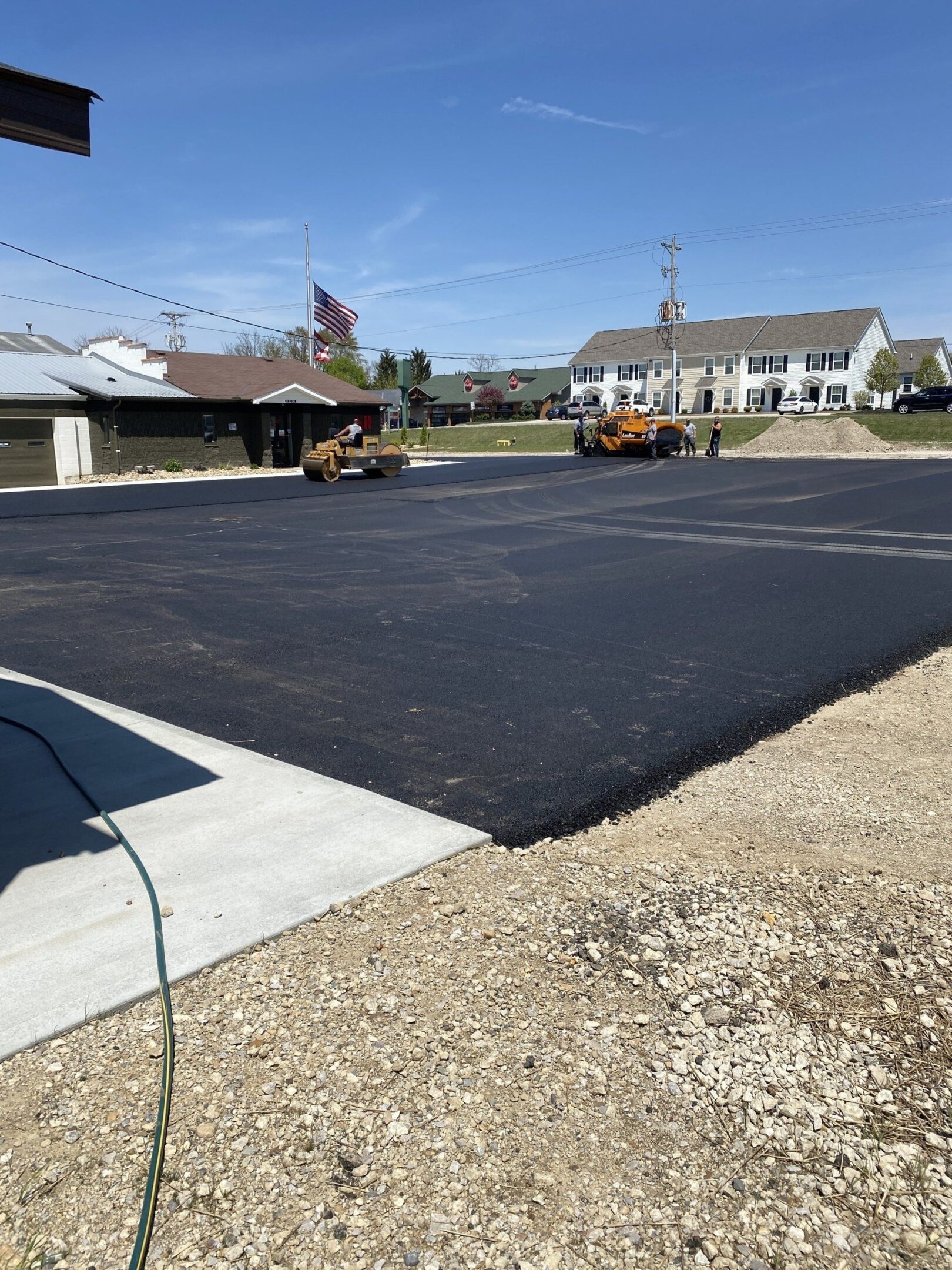Freshly paved parking lot under clear sky
